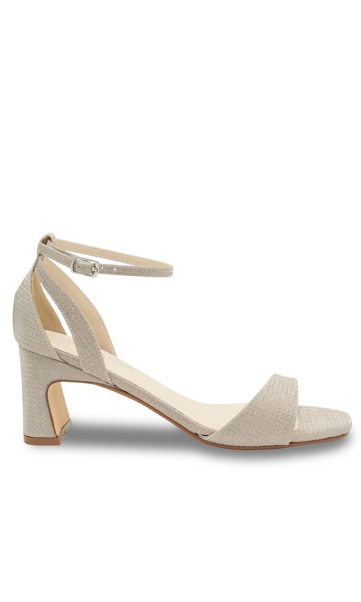 A single Lilibet Champagne Prom Shoe by Touch Ups (style 4670) in light beige, featuring a textured finish, open toe, ankle strap, and small block heel—an elegant low-heel choice for prom. Shown in side profile on a white background.